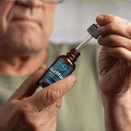 Man holding Audifort hearing supplement